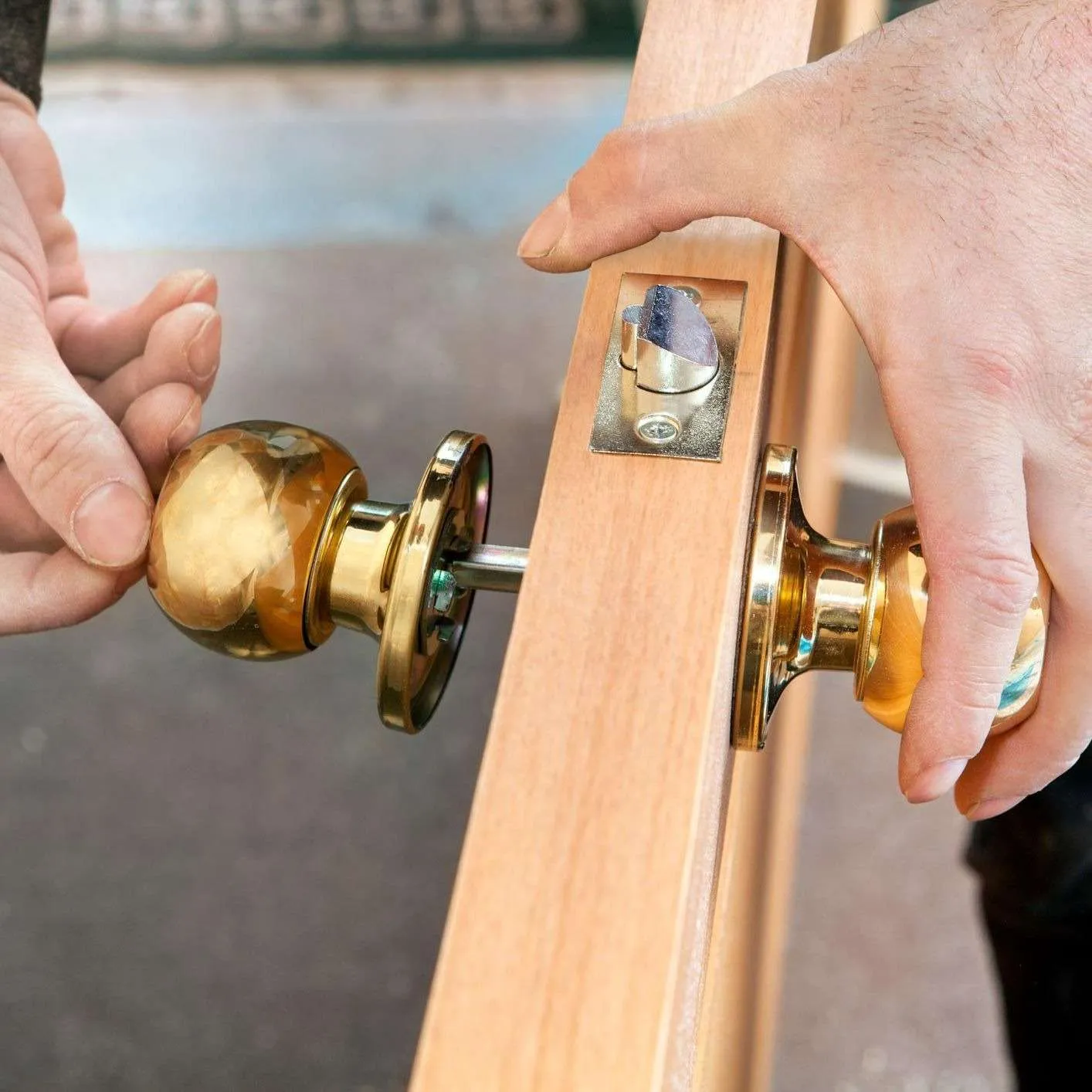 Installing door knob on wooden door.